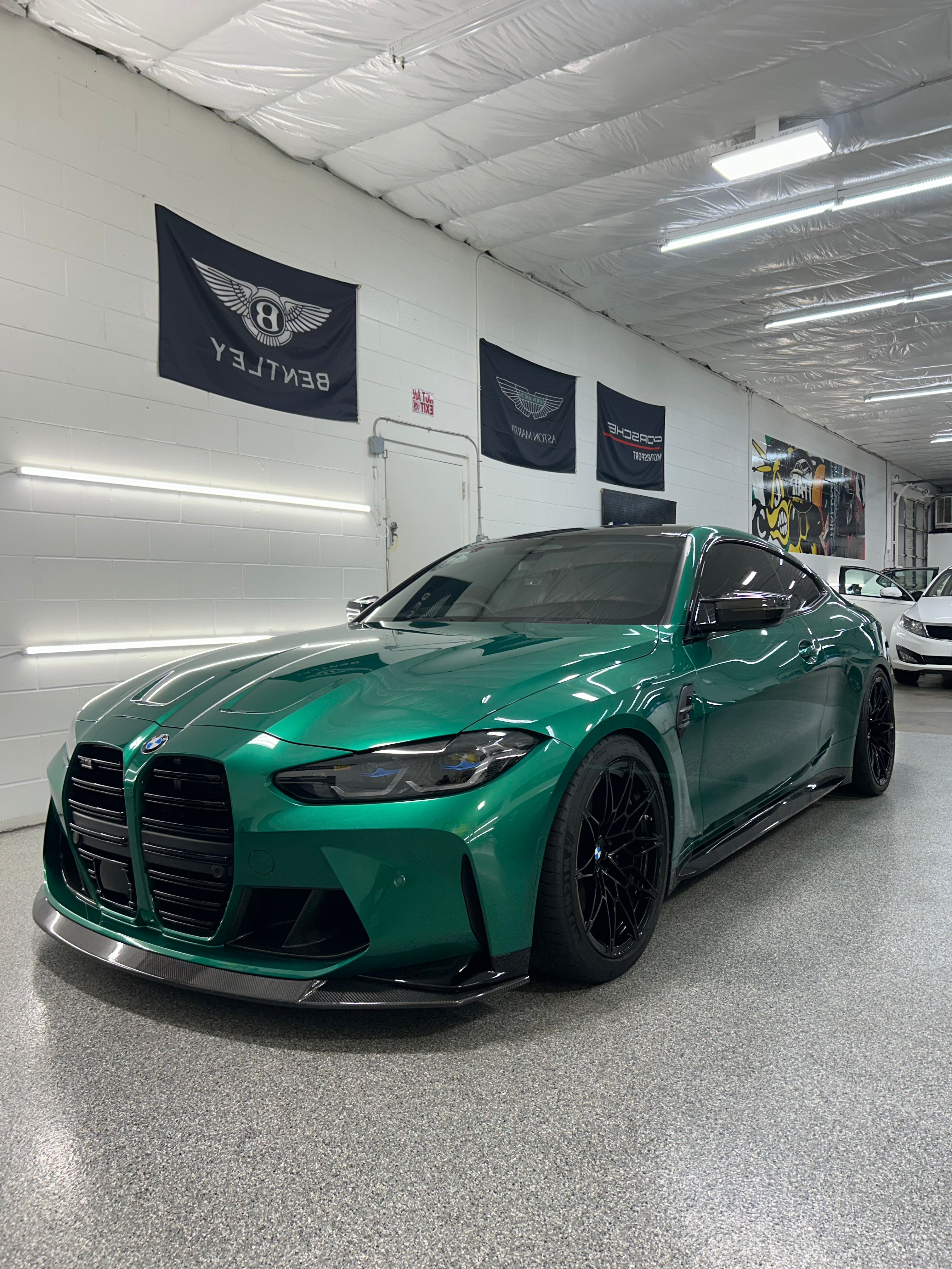 Green BMW car in a showroom with 2 WINDOW TINT in Tampa , Florida